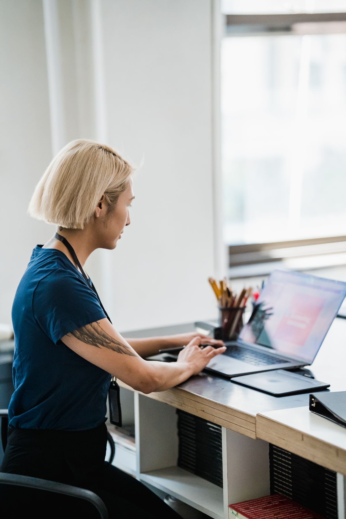 Professional werkt geconcentreerd op een laptop in een modern kantoor, passend bij Microsoft 365 Copilot voor het MKB